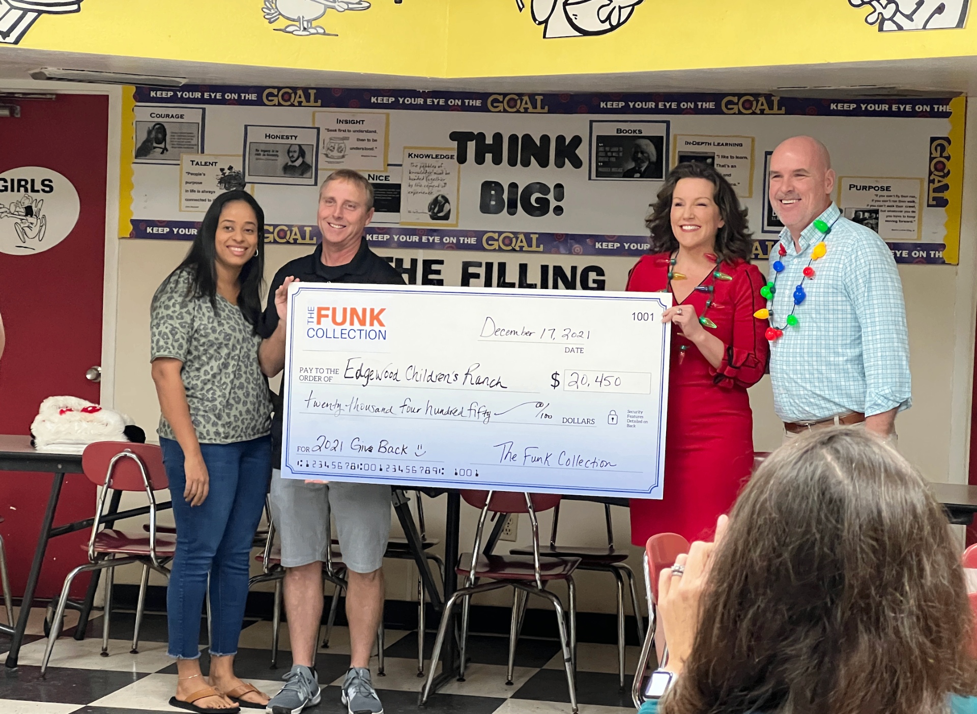 The Funk Collection presenting a $20,450 check to Edgewood Children's Ranch for 2021 Give Back