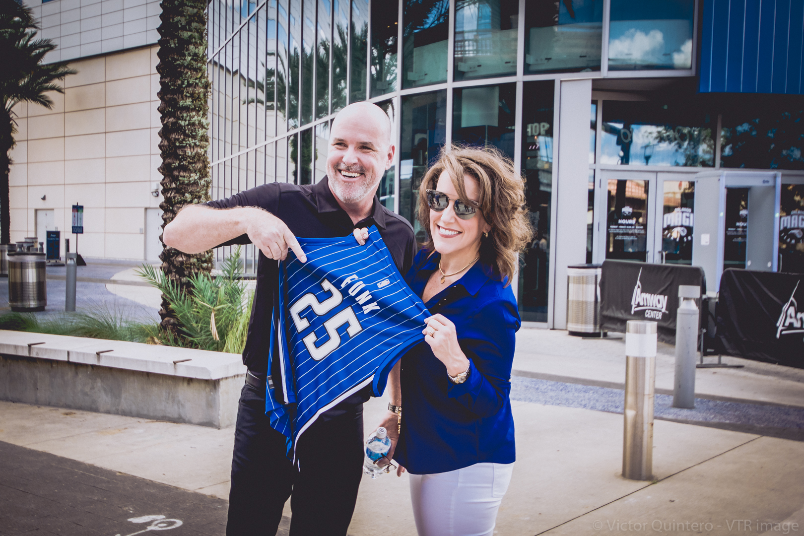 Jeff and Renee Funk outside Amway Center holding a custom Orlando Magic jersey reading FUNK 25.