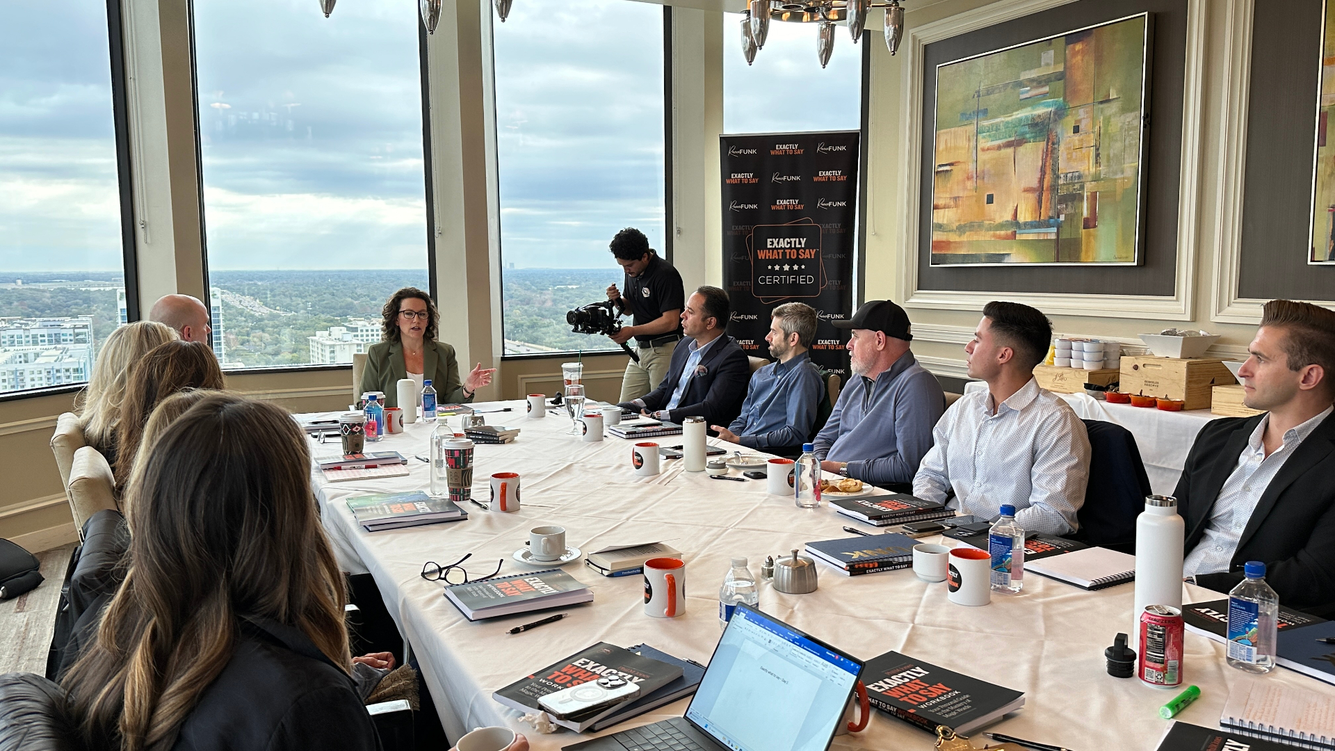 Renee Funk leading an Exactly What to Say training in a high-rise boardroom